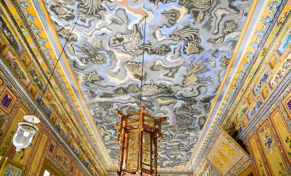 A unique ceiling painting depicting flying dragons and dancing phoenixes in dark purple and black – the only surviving ceiling artwork of its kind in Vietnam 